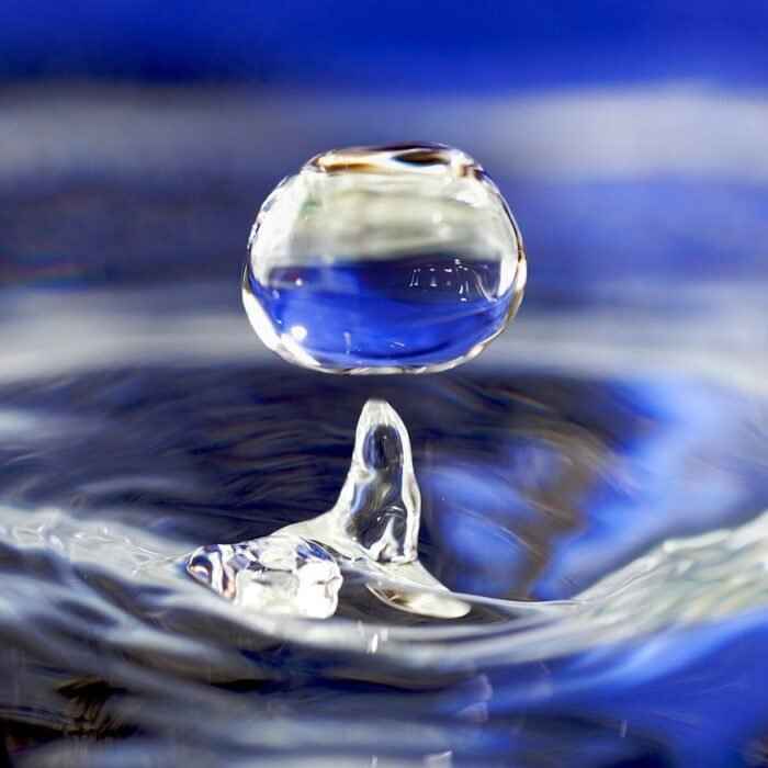 A water droplet falling into water