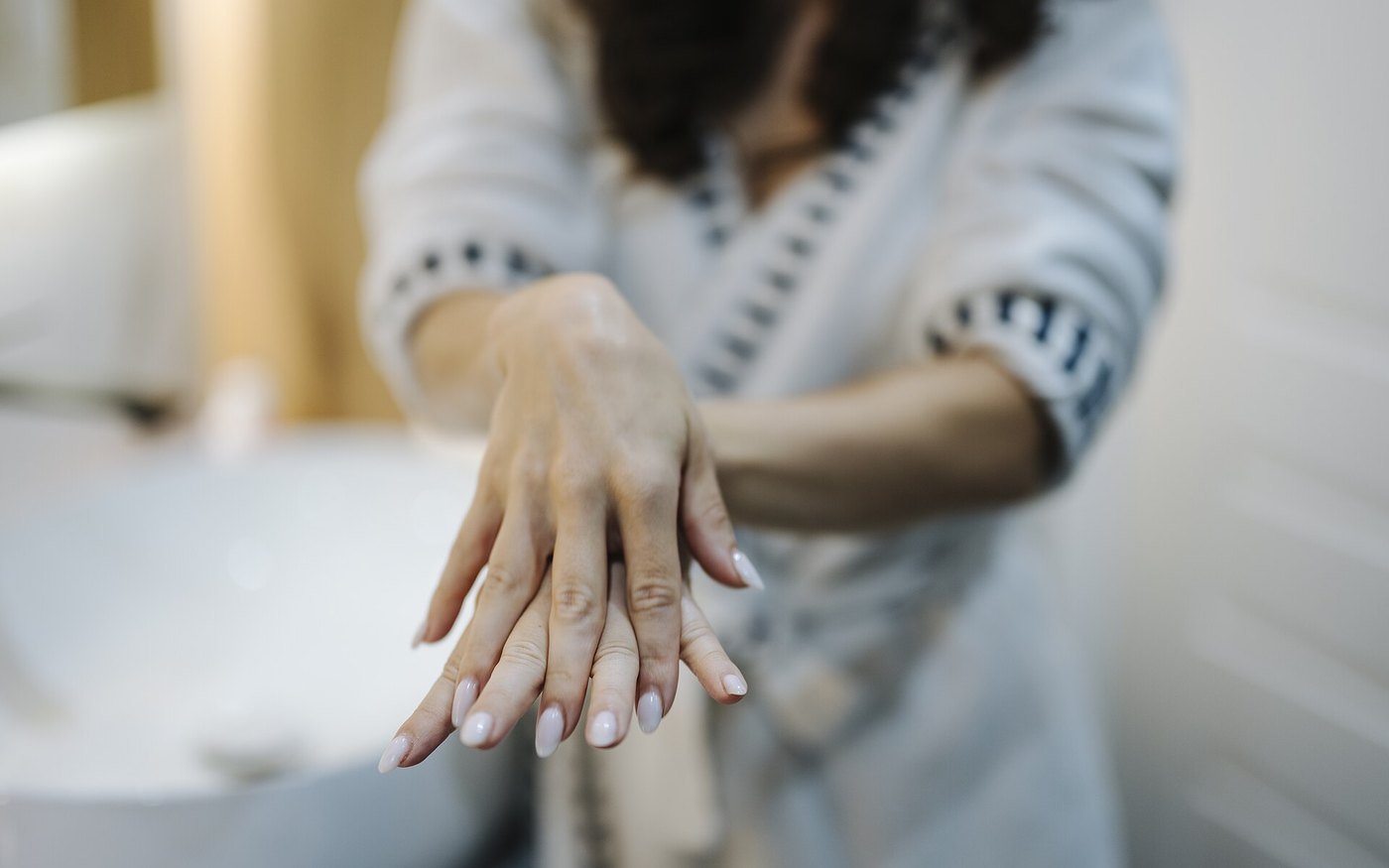 Hands applying a cream